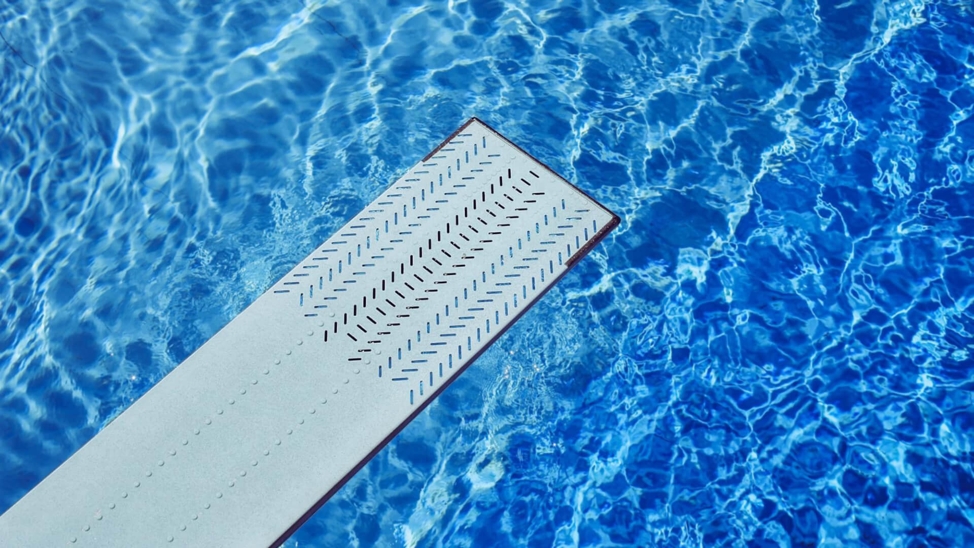 
		A diving board over clear blue water		