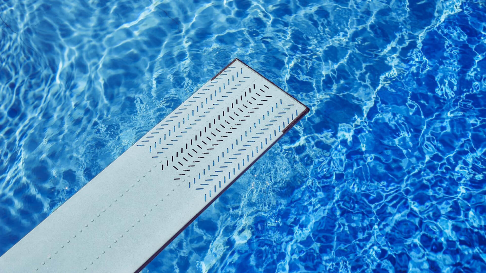 A diving board over clear blue water