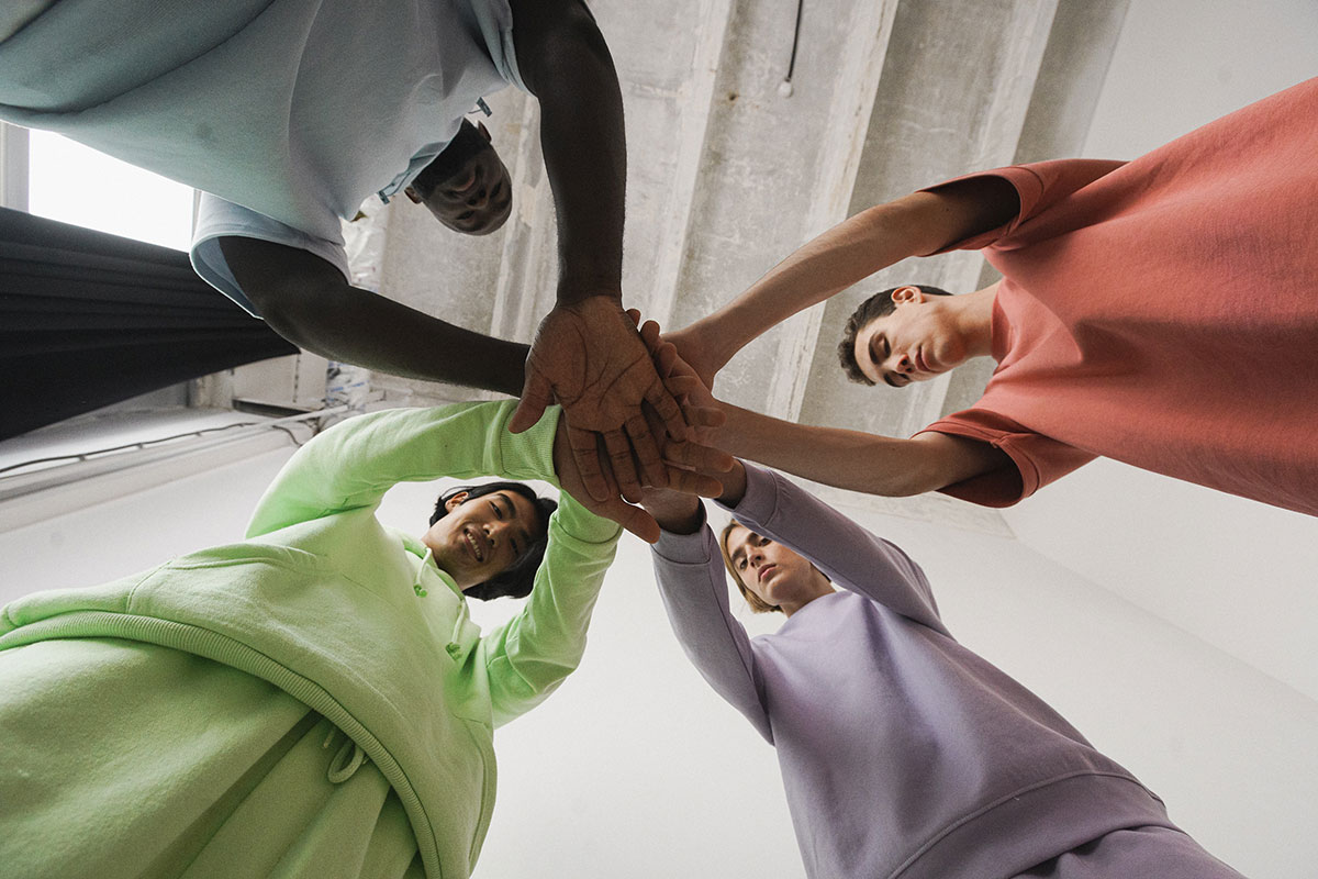 A group of people stacking their hands