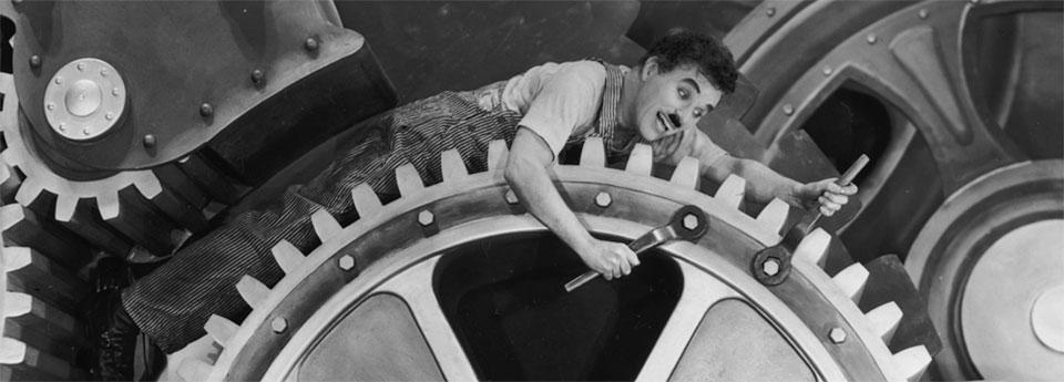 Charlie Chaplin wrenching on a giant cog