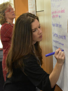 Charmaine Farber writes on a poster